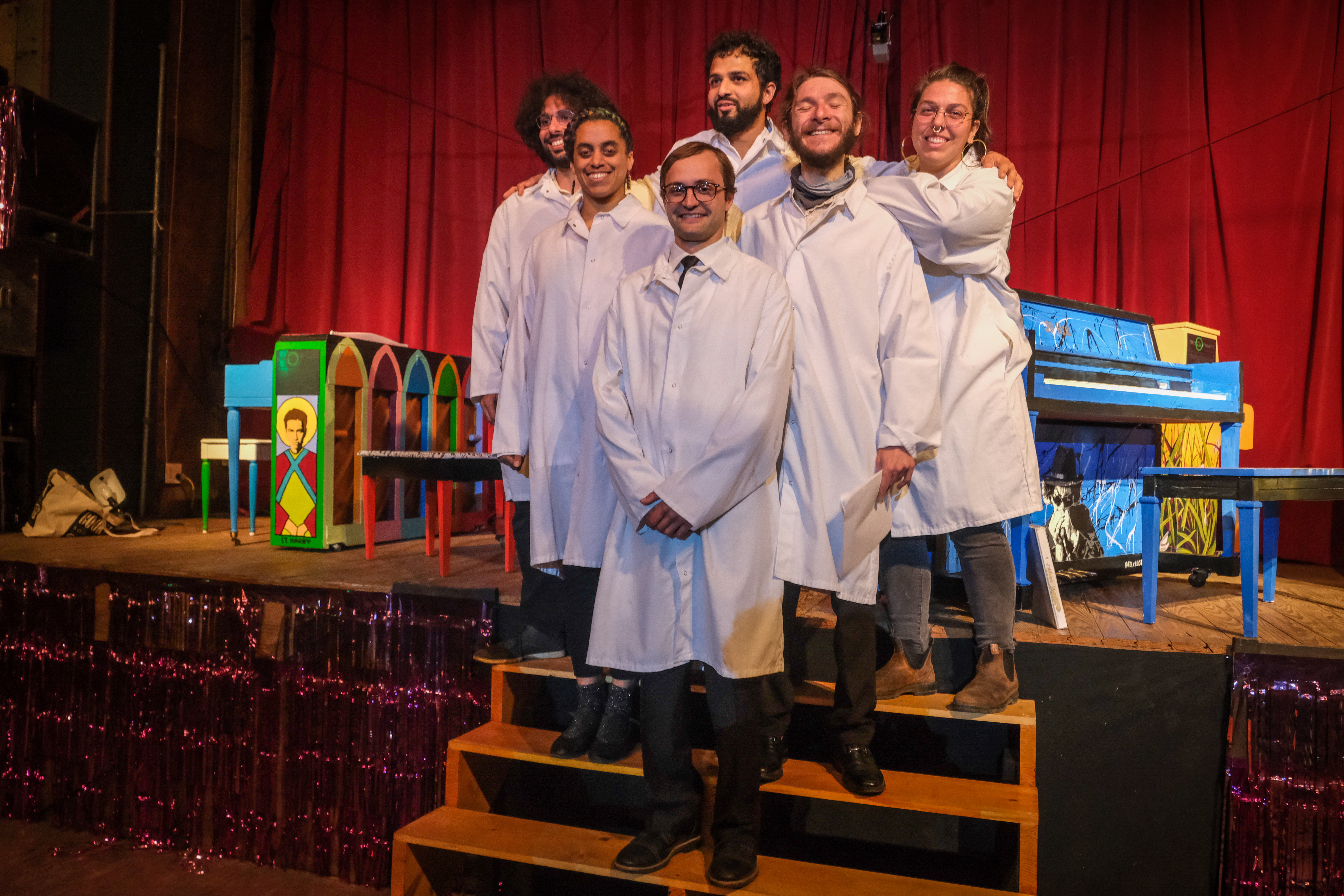 performers' group photo in white lab coats